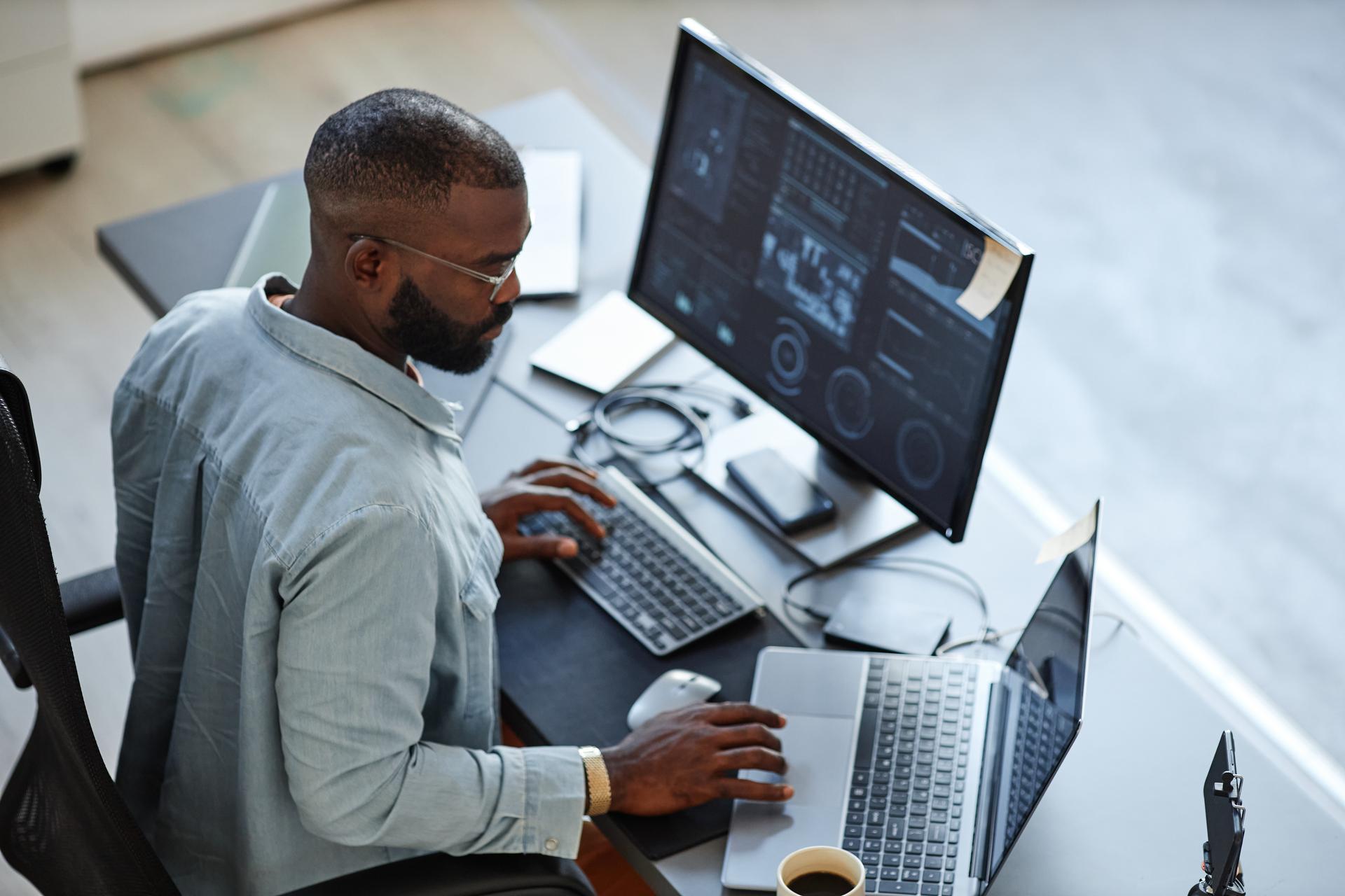 Man using computer with dual monitor